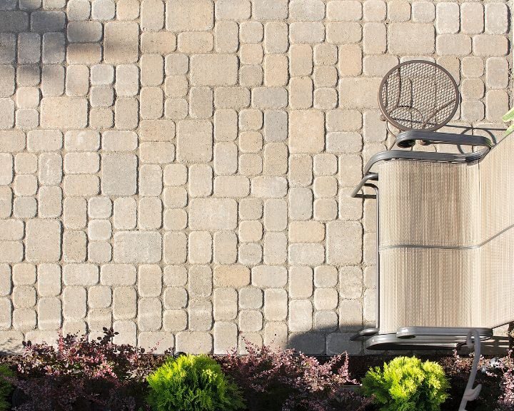 A city patio with concrete pavers in the background.