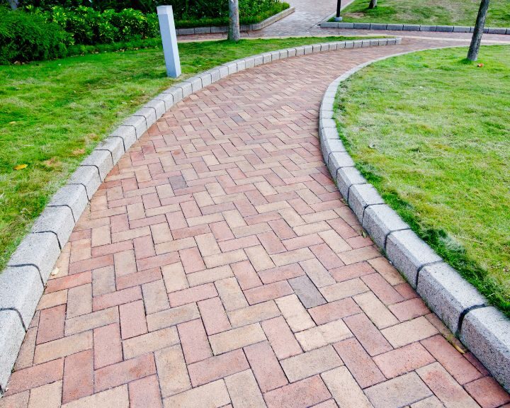 A city park with a concrete paver walkway.