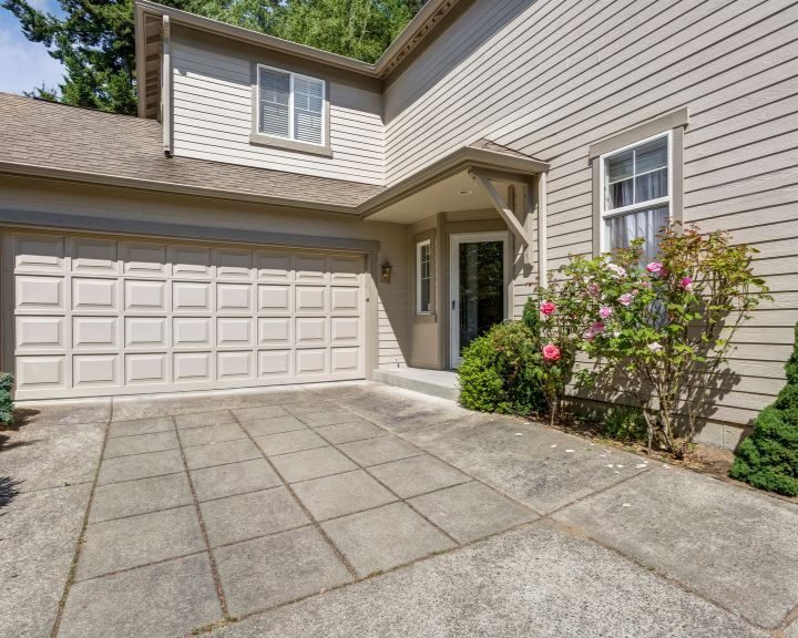 A city home with a concrete slabs leading to a garage.